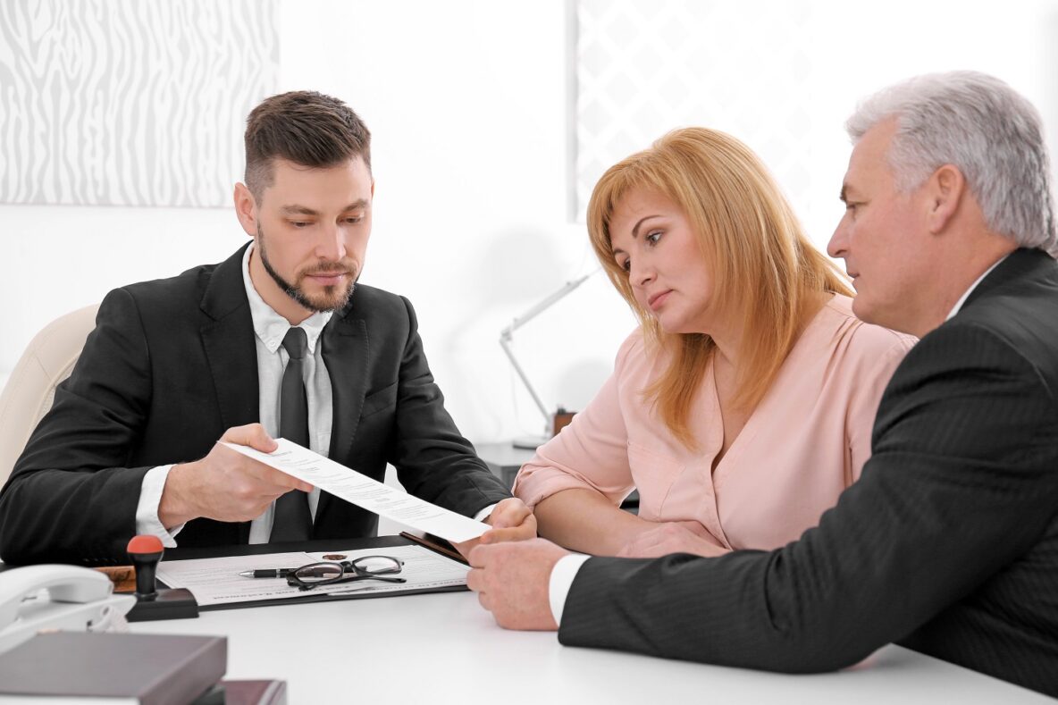 older couple with insurer reviewing paper